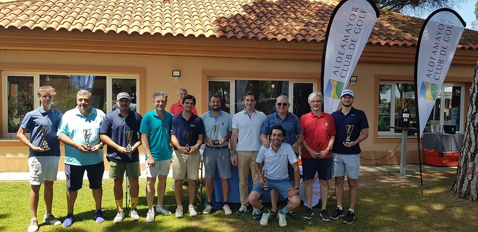 Golf tournament participants pose with trophies outside the Aldeamayor Club de Golf clubhouse.