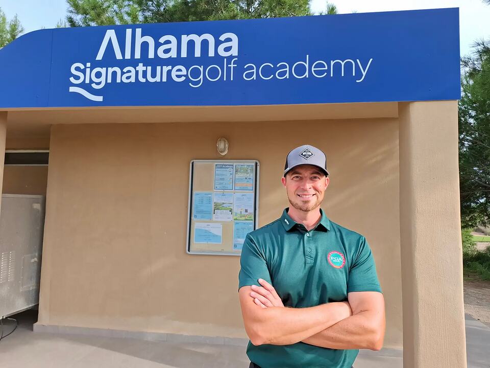 Golf instructor standing outside the Alhama Signature Golf Academy entrance