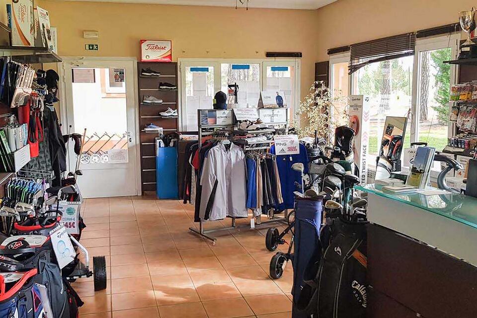 Golf equipment and clothing displayed inside the pro shop at Aldeamayor Club de Golf