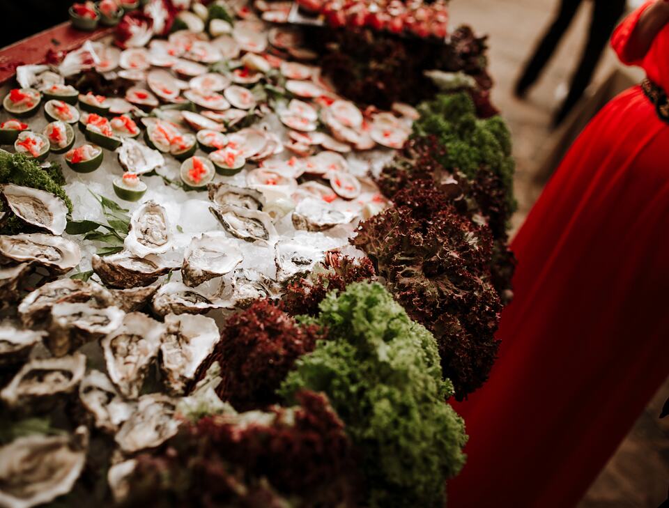 Oysters and assorted seafood arranged on ice at a social event