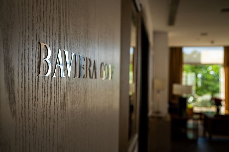Baviera Golf lettering on a wooden wall beside the clubhouse lounge
