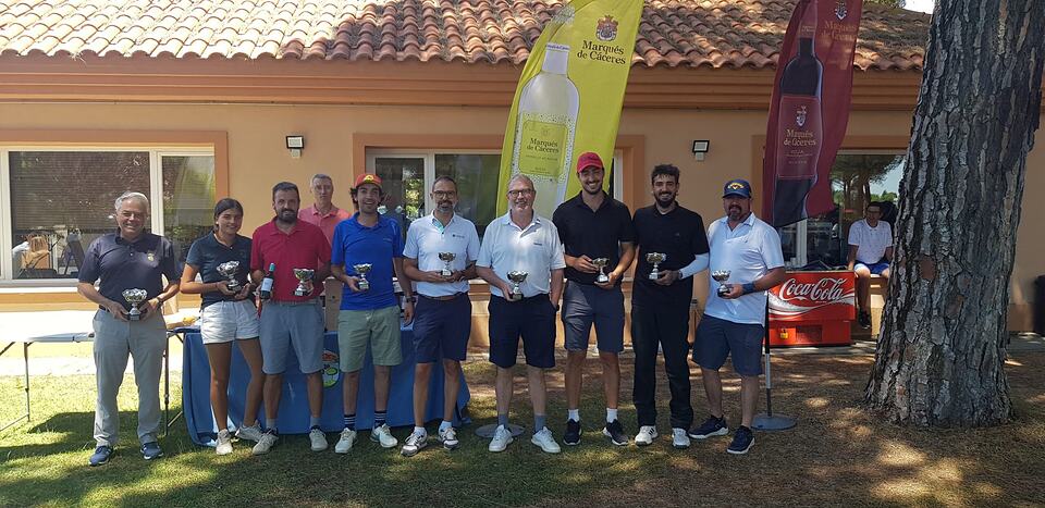 Golf tournament participants pose with trophies outside the clubhouse.